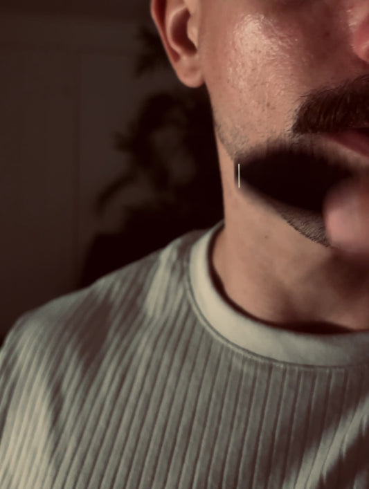 Alexander brushing his mustache with the Ochre brush